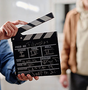 Filmmaking Scene with Film Clapper and Crew Members